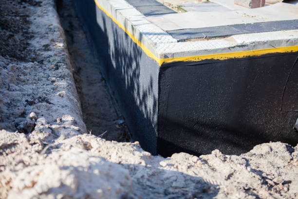 Professional Basement Waterproofing technician working in Clarksburg, OH